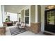 Cozy front porch with stone accents, decorative columns, and comfortable seating for relaxing outdoors at 113 Hidden Bluff Dr, Chapel Hill, NC 27517