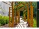 Inviting garden path featuring a wooden arbor and lush landscaping, creating a tranquil outdoor experience at 113 Hidden Bluff Dr, Chapel Hill, NC 27517