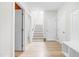 Spacious hallway featuring a staircase, wood floors and hall tree for storage at 113 Hidden Bluff Dr, Chapel Hill, NC 27517