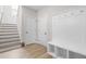 Hallway featuring staircase, wood floors, hall tree and hooks for storage at 113 Hidden Bluff Dr, Chapel Hill, NC 27517