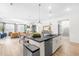 Open-concept kitchen with island, granite countertops, and stainless steel appliances seamlessly flows into the inviting living spaces at 113 Hidden Bluff Dr, Chapel Hill, NC 27517