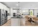 Bright, spacious kitchen with stainless steel appliances, a large island, and an adjacent dining area at 113 Hidden Bluff Dr, Chapel Hill, NC 27517