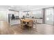 Bright modern kitchen features stainless steel appliances, a breakfast bar, and an adjacent dining area with a round wooden table at 113 Hidden Bluff Dr, Chapel Hill, NC 27517