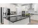 Contemporary kitchen featuring a large island with a stone countertop, stainless steel appliances, and pendant lighting at 113 Hidden Bluff Dr, Chapel Hill, NC 27517