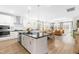 Spacious kitchen open to the living area, featuring a central island with granite countertops and stainless steel appliances at 113 Hidden Bluff Dr, Chapel Hill, NC 27517