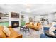 Comfortable living room with a fireplace, plush leather sofas, and open access to the dining and kitchen areas at 113 Hidden Bluff Dr, Chapel Hill, NC 27517