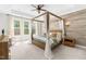 Spacious main bedroom showcases a wood canopy bed, lots of light, and neutral tones, creating a relaxing retreat at 113 Hidden Bluff Dr, Chapel Hill, NC 27517