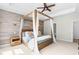 Charming main bedroom features a wooden canopy bed with soft linens, accent wall and a serene, inviting ambiance at 113 Hidden Bluff Dr, Chapel Hill, NC 27517