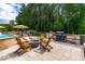 Outdoor stone kitchen and patio with fire pit provide a great outdoor space for entertainment at 113 Hidden Bluff Dr, Chapel Hill, NC 27517