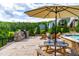 Outdoor stone kitchen and patio area provides perfect space for cooking and entertaining by the water at 113 Hidden Bluff Dr, Chapel Hill, NC 27517