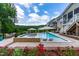 Lovely backyard pool, spa, outdoor kitchen, and flowers create a serene outdoor living space at 113 Hidden Bluff Dr, Chapel Hill, NC 27517