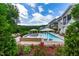 Backyard pool features a spa, tanning ledge, and flowering plants create a private outdoor oasis at 113 Hidden Bluff Dr, Chapel Hill, NC 27517
