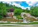 Picturesque cascading water feature with lush landscaping and natural stone details, adding to community's tranquility at 113 Hidden Bluff Dr, Chapel Hill, NC 27517