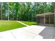 Backyard features a patio, shed, lush lawn, and mature trees for outdoor enjoyment at 11817 Coachmans Way, Raleigh, NC 27614
