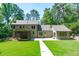 Expansive backyard featuring a lush lawn, patio, and mature trees at 11817 Coachmans Way, Raleigh, NC 27614