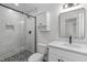 Modern bathroom features glass-enclosed shower, updated vanity, and stylish tile flooring at 11817 Coachmans Way, Raleigh, NC 27614