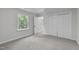 Bright bedroom with large window, plush carpet, and closet offers a serene retreat at 11817 Coachmans Way, Raleigh, NC 27614