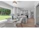 Breakfast nook features a white table, three chairs, a view into the kitchen, and a large window at 11817 Coachmans Way, Raleigh, NC 27614