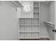 Spacious walk-in closet with custom shelving and an octagonal window for natural light at 11817 Coachmans Way, Raleigh, NC 27614