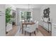 Bright dining room featuring a chandelier, seating for eight, and natural light streaming in from the window at 11817 Coachmans Way, Raleigh, NC 27614