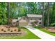 Charming two-story home with neutral siding, attached garage, and long driveway surrounded by lush trees at 11817 Coachmans Way, Raleigh, NC 27614