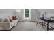 Comfortable living room featuring a cozy sofa, desk area, and natural light at 11817 Coachmans Way, Raleigh, NC 27614