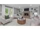 Bright living room with built-in bookshelves, stone fireplace, and comfortable seating arrangements at 11817 Coachmans Way, Raleigh, NC 27614