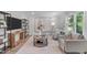 Modern living room with neutral colors, stylish furniture, contemporary art, and bright natural light at 11817 Coachmans Way, Raleigh, NC 27614