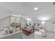 Spacious living room with bright windows, couches, seating and side tables at 11817 Coachmans Way, Raleigh, NC 27614