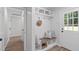 Welcoming mudroom with built-in bench, storage, and convenient coat hooks by the front door entrance at 11817 Coachmans Way, Raleigh, NC 27614