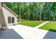 A concrete patio and well-maintained lawn create a relaxing outdoor space at 11817 Coachmans Way, Raleigh, NC 27614
