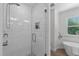 Modern shower with glass door, white subway tiles, and a convenient built-in niche at 11817 Coachmans Way, Raleigh, NC 27614
