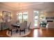 Open floor plan with a dining table set with six chairs and view into the living room at 1205 Bridgeforth Ln, Chapel Hill, NC 27517