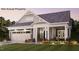 Charming single-story home featuring manicured landscaping and a welcoming front porch at 1205 Bridgeforth Ln, Chapel Hill, NC 27517