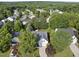 An aerial view of a white home with mature trees in a quiet residential neighborhood at 12505 Garden Tree Ln, Raleigh, NC 27614