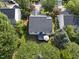 Aerial view of a private backyard featuring a deck, lush landscaping, and mature trees at 12505 Garden Tree Ln, Raleigh, NC 27614