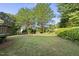 Large backyard with lush green grass and privacy provided by mature trees and foliage at 12505 Garden Tree Ln, Raleigh, NC 27614