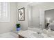 Bathroom with soaking tub, a large mirror and vanity plus plantation shutters on the window at 12505 Garden Tree Ln, Raleigh, NC 27614