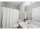 A bathroom with a white shower curtain, toilet, and sink at 12505 Garden Tree Ln, Raleigh, NC 27614