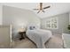 A well-lit bedroom with neutral colors and carpet features a ceiling fan and shutters at 12505 Garden Tree Ln, Raleigh, NC 27614