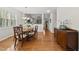 Dining room with chandelier, hardwood floors, and access to the living room and entryway at 12505 Garden Tree Ln, Raleigh, NC 27614