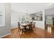 Sunlit dining area with hardwood floors, chandelier, and a view into the spacious living room at 12505 Garden Tree Ln, Raleigh, NC 27614