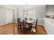 Elegant dining room featuring hardwood floors, wainscoting, shutters, and a chandelier at 12505 Garden Tree Ln, Raleigh, NC 27614