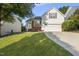 Charming home with a well-manicured lawn, two car garage, and a mix of brick and siding at 12505 Garden Tree Ln, Raleigh, NC 27614