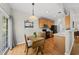 View of the kitchen with a table and chairs. The room is well-lit with wooden cabinets at 12505 Garden Tree Ln, Raleigh, NC 27614