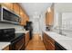 A kitchen boasts wooden cabinets, stainless appliances, and hardwood floors, with an open layout at 12505 Garden Tree Ln, Raleigh, NC 27614