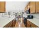 A view of the kitchen leading to a dining area with hardwood floors and neutral paint at 12505 Garden Tree Ln, Raleigh, NC 27614