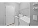 Clean laundry room with modern appliances and storage at 12505 Garden Tree Ln, Raleigh, NC 27614