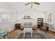 Cozy living room featuring a vaulted ceiling, plush sofa, and warm, inviting decor at 12505 Garden Tree Ln, Raleigh, NC 27614
