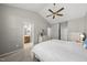 Bright main bedroom features neutral walls, a vaulted ceiling, a ceiling fan, and ensuite bathroom at 12505 Garden Tree Ln, Raleigh, NC 27614